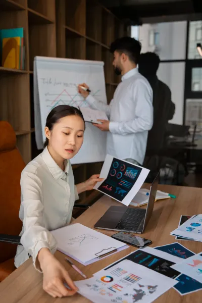 HR staff reviewing reports at her desk