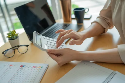 Calculating salaries by hand with a calculator and spreadsheet